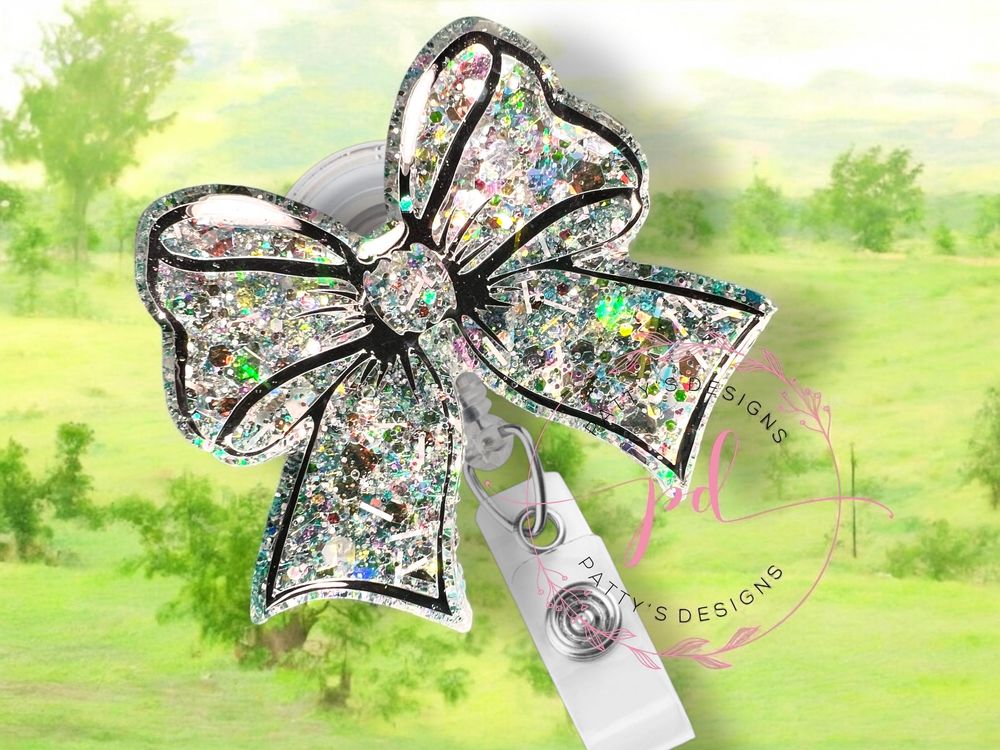 White Bow with hues of Green and Pink Badge Reel
